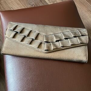 Rolf’s Bronze clutch handbag